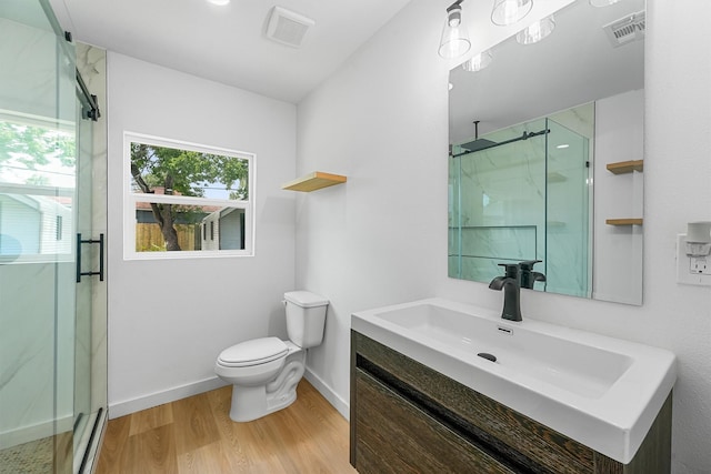 3303 Dartmouth Dr, Pasadena, TX 77503 - bathroom featuring a marble finish shower, vanity, and wood finished floors