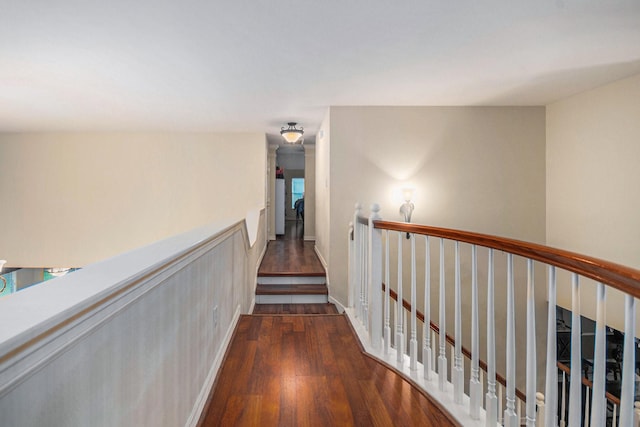 305 Pinnacle Cove Ct, League City, TX 77573 - corridor featuring an upstairs landing, dark wood-type flooring, and wainscoting