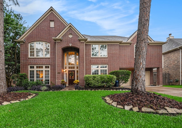 305 Pinnacle Cove Ct, League City, TX 77573 - view of front of house with brick siding, a front lawn, and driveway