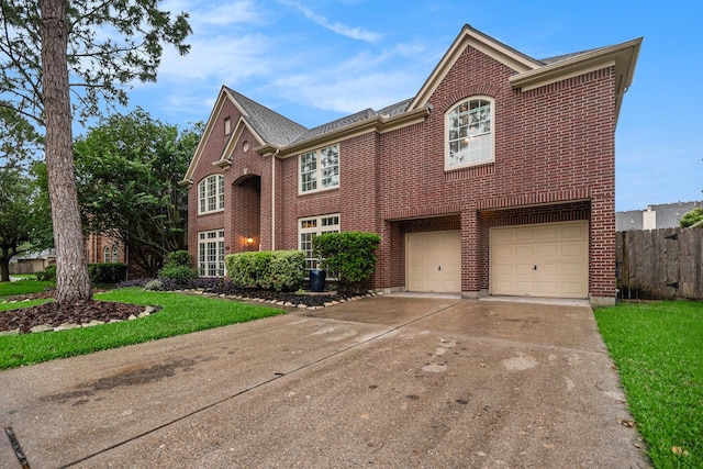 305 Pinnacle Cove Ct, League City, TX 77573 - view of front of home featuring brick siding, an attached garage, and concrete driveway