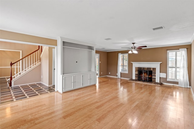 2802 Sandpebble Dr, Seabrook, TX 77586 - unfurnished living room featuring a ceiling fan, plenty of natural light, light wood-type flooring, and ornamental molding