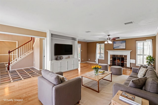 2802 Sandpebble Dr, Seabrook, TX 77586 - living area featuring ceiling fan, plenty of natural light, light wood-style floors, and ornamental molding
