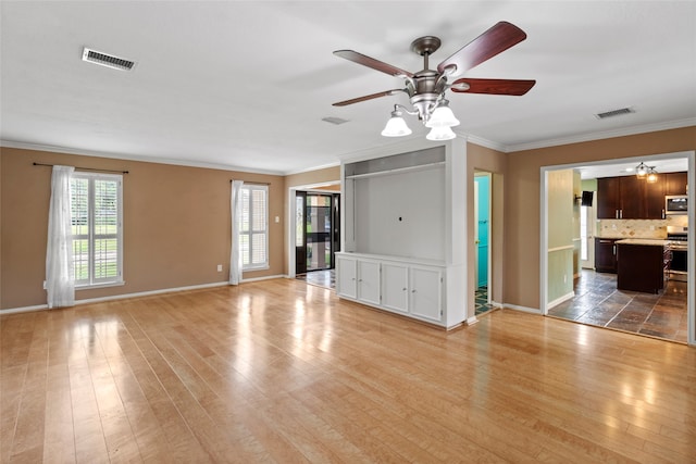 2802 Sandpebble Dr, Seabrook, TX 77586 - unfurnished living room featuring a ceiling fan, ornamental molding, and light wood finished floors