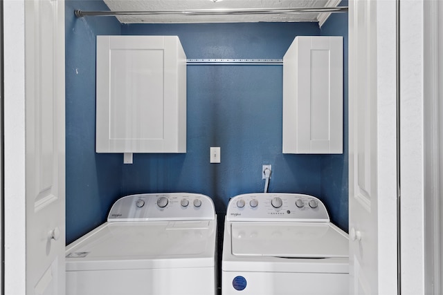 2802 Sandpebble Dr, Seabrook, TX 77586 - laundry room featuring washing machine and clothes dryer and cabinet space