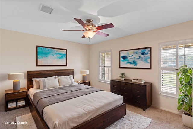 2802 Sandpebble Dr, Seabrook, TX 77586 - bedroom with light carpet, multiple windows, and a ceiling fan