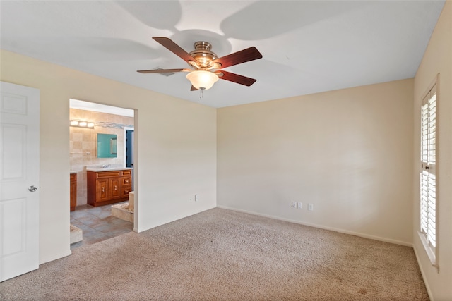 2802 Sandpebble Dr, Seabrook, TX 77586 - unfurnished bedroom with light carpet, multiple windows, connected bathroom, and ceiling fan