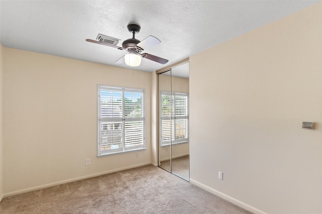 2802 Sandpebble Dr, Seabrook, TX 77586 - unfurnished bedroom with carpet, a closet, a ceiling fan, and a textured ceiling
