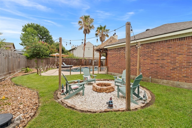 2802 Sandpebble Dr, Seabrook, TX 77586 - fenced backyard featuring a fire pit, a patio, and a swimming pool