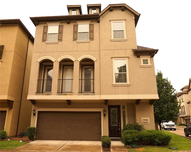 12248 Oxford Crescent Cir, Houston, TX 77082 - multi unit property featuring stucco siding, an attached garage, concrete driveway, and a balcony