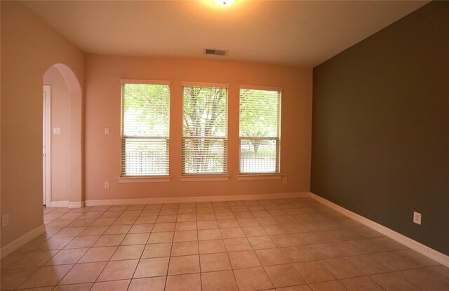 12248 Oxford Crescent Cir, Houston, TX 77082 - spare room featuring arched walkways, plenty of natural light, and light tile patterned floors