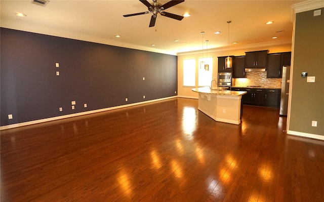 12248 Oxford Crescent Cir, Houston, TX 77082 - kitchen with crown molding, freestanding refrigerator, dark wood finished floors, a center island with sink, and a ceiling fan
