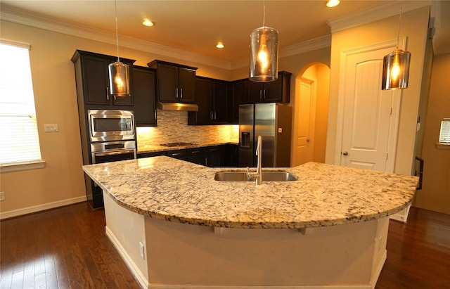 12248 Oxford Crescent Cir, Houston, TX 77082 - kitchen with stainless steel appliances, arched walkways, dark wood-style flooring, decorative backsplash, and light stone countertops