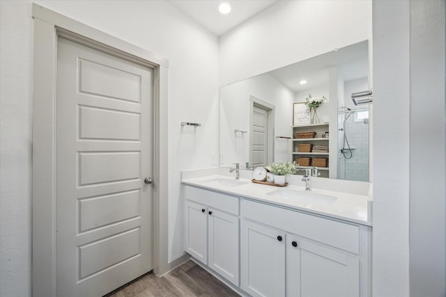 7714 Cattleman Valley Dr, Rosharon, TX 77583 - bathroom featuring tiled shower, double vanity, wood finished floors, and recessed lighting