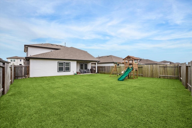 7714 Cattleman Valley Dr, Rosharon, TX 77583 - rear view of property with a playground and a fenced backyard