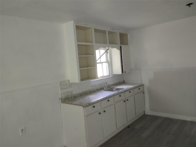 3950 Scranton St, Beaumont, TX 77703 - kitchen featuring wood finished floors, a wainscoted wall, white cabinets, and light countertops