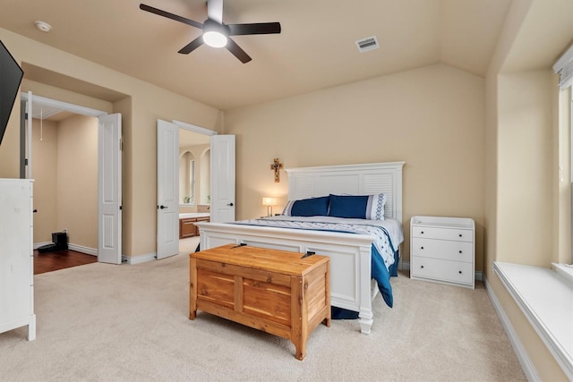 10010 Friesian Estates Dr, Spring, TX 77379 - bedroom with light carpet, connected bathroom, lofted ceiling, and ceiling fan