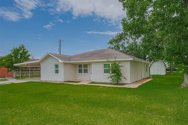 2401 33rd Ave N, Texas City, TX 77590 - back of property featuring a storage shed, an attached carport, brick siding, and driveway