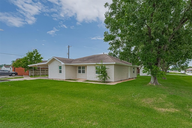 2401 33rd Ave N, Texas City, TX 77590 - view of front of house with a carport, a front lawn, and brick siding