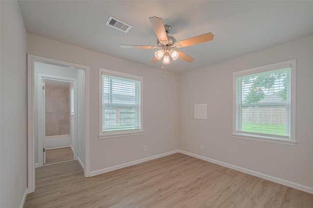 2401 33rd Ave N, Texas City, TX 77590 - unfurnished room with healthy amount of natural light, light wood finished floors, and a ceiling fan