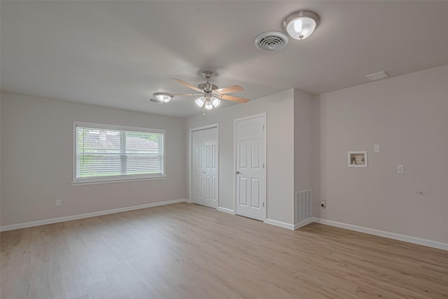 2401 33rd Ave N, Texas City, TX 77590 - unfurnished bedroom featuring light wood-style flooring, ceiling fan, and two closets
