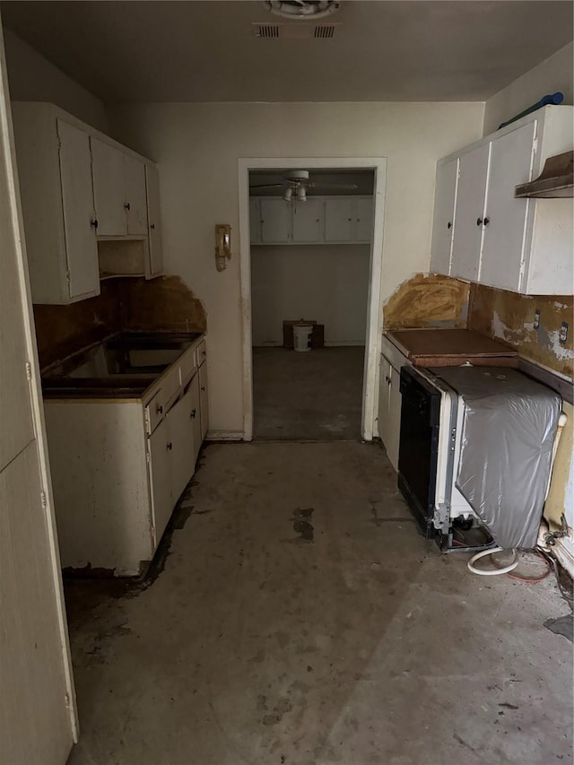 5050 Nassau Rd, Houston, TX 77021 - kitchen featuring white cabinetry, unfinished concrete floors, and dark countertops