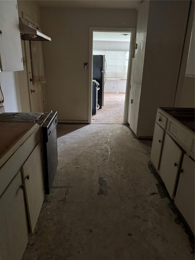 5050 Nassau Rd, Houston, TX 77021 - kitchen featuring freestanding refrigerator, white cabinetry, and unfinished concrete floors