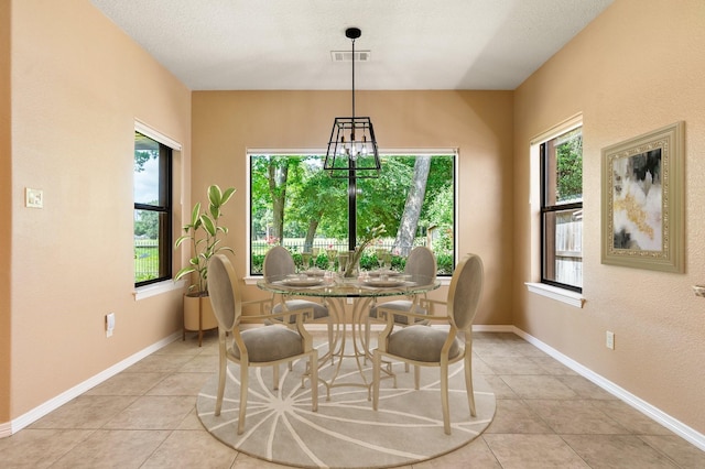 13727 Fountainview Dr, Montgomery, TX 77356 - dining space featuring plenty of natural light, light tile patterned flooring, and a chandelier