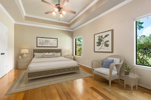 13727 Fountainview Dr, Montgomery, TX 77356 - bedroom featuring multiple windows, light wood-type flooring, a raised ceiling, crown molding, and ceiling fan