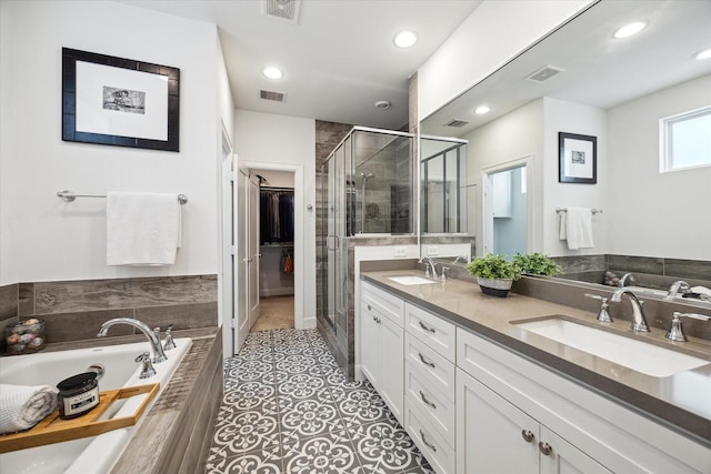 1050 Timbergrove Yards Ln, Houston, TX 77008 - bathroom with double vanity, a shower stall, a garden tub, recessed lighting, and a walk in closet