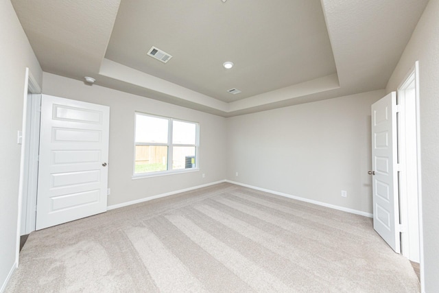 8104 Vanilla Orchid Dr, Houston, TX 77016 - unfurnished bedroom with a tray ceiling and carpet floors