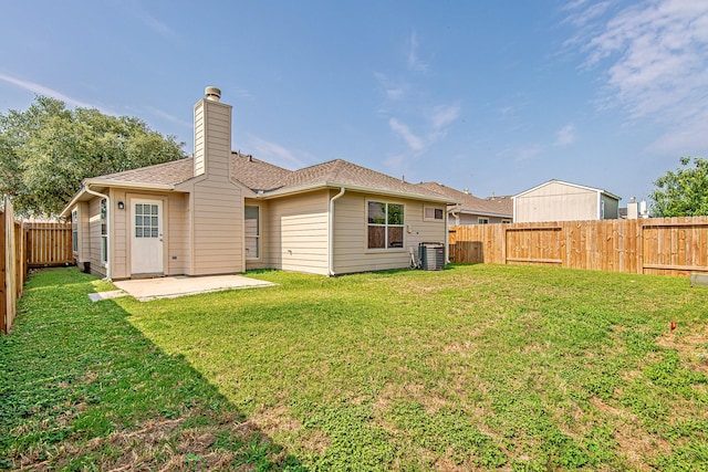 11230 Chelsea Oak St, Houston, TX 77065 - back of house with a fenced backyard, a patio area, a chimney, and roof with shingles