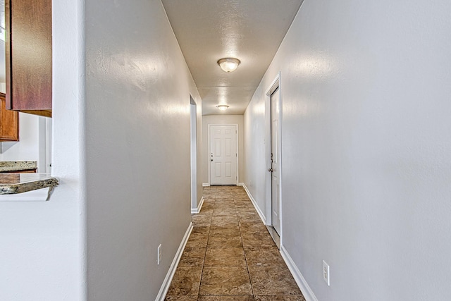 11230 Chelsea Oak St, Houston, TX 77065 - hall with baseboards and dark stone finish floors