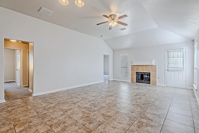 11230 Chelsea Oak St, Houston, TX 77065 - unfurnished living room featuring a ceiling fan, vaulted ceiling, and a tile fireplace