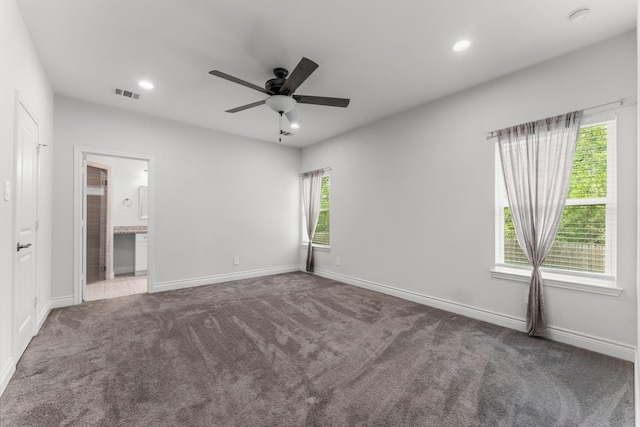 719 Cherokee Dr, Conroe, TX 77316 - unfurnished bedroom featuring carpet flooring, recessed lighting, ensuite bathroom, and a ceiling fan