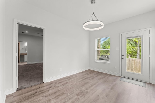 719 Cherokee Dr, Conroe, TX 77316 - unfurnished dining area featuring wood finished floors and baseboards