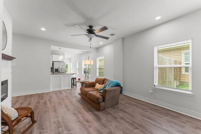 719 Cherokee Dr, Conroe, TX 77316 - living area with ceiling fan, light wood-style floors, healthy amount of natural light, and recessed lighting