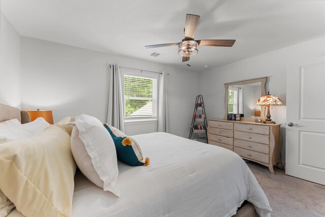 719 Cherokee Dr, Conroe, TX 77316 - bedroom with light carpet and a ceiling fan