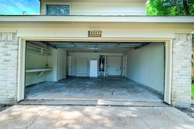 6507 Desert Rose Ln, Houston, TX 77086 - garage featuring driveway and freestanding refrigerator
