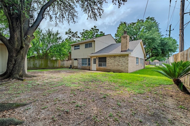 6507 Desert Rose Ln, Houston, TX 77086 - back of house featuring brick siding, a chimney, and a fenced backyard