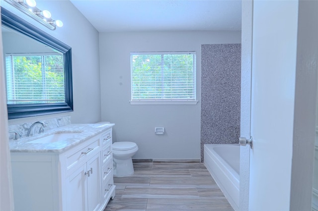 6507 Desert Rose Ln, Houston, TX 77086 - full bath with vanity, a tub to relax in, and wood finished floors