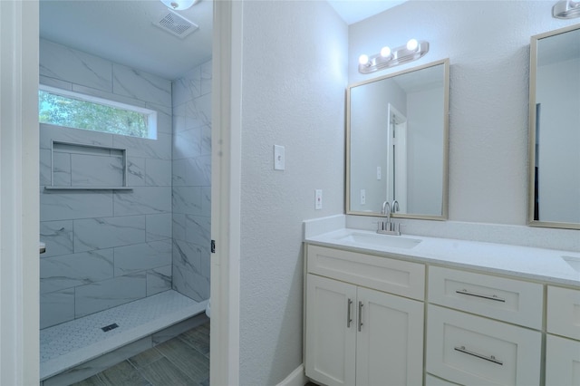 6507 Desert Rose Ln, Houston, TX 77086 - bathroom featuring double vanity and a tile shower