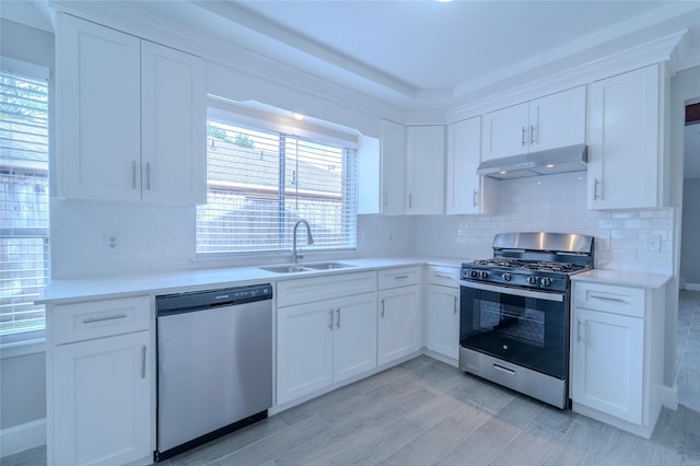 6507 Desert Rose Ln, Houston, TX 77086 - kitchen featuring stainless steel appliances, under cabinet range hood, white cabinets, and light countertops