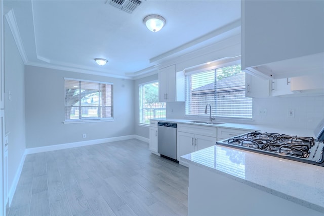 6507 Desert Rose Ln, Houston, TX 77086 - kitchen with stainless steel dishwasher, light stone countertops, crown molding, light wood-type flooring, and white cabinets