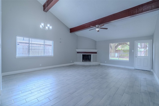 6507 Desert Rose Ln, Houston, TX 77086 - unfurnished living room featuring a ceiling fan, a chandelier, a brick fireplace, and light wood-style floors