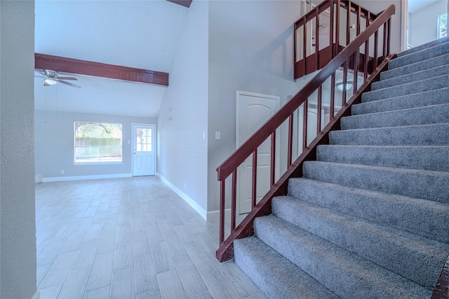 6507 Desert Rose Ln, Houston, TX 77086 - stairs featuring a ceiling fan, wood finished floors, beam ceiling, and high vaulted ceiling