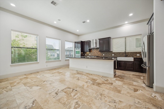 5411 Gibson St, Houston, TX 77007 - kitchen featuring wall chimney range hood, ornamental molding, dark countertops, tasteful backsplash, and appliances with stainless steel finishes