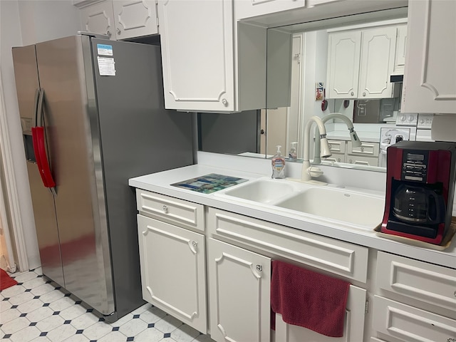 5050 Ambassador Way Unit 201, Houston, TX 77056 - kitchen featuring stainless steel fridge with ice dispenser, light countertops, white cabinetry, and light floors