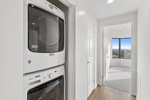 2001 Holcombe Blvd Unit 2305, Houston, TX 77030 - laundry area with stacked washing machine and dryer, light wood finished floors, and recessed lighting