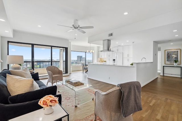 2001 Holcombe Blvd Unit 2305, Houston, TX 77030 - living area featuring ceiling fan, light wood finished floors, recessed lighting, and a chandelier