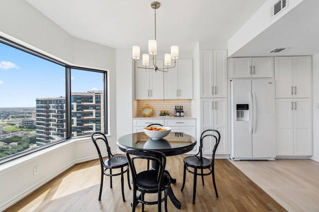 2001 Holcombe Blvd Unit 2305, Houston, TX 77030 - dining area featuring light wood-style flooring and a chandelier
